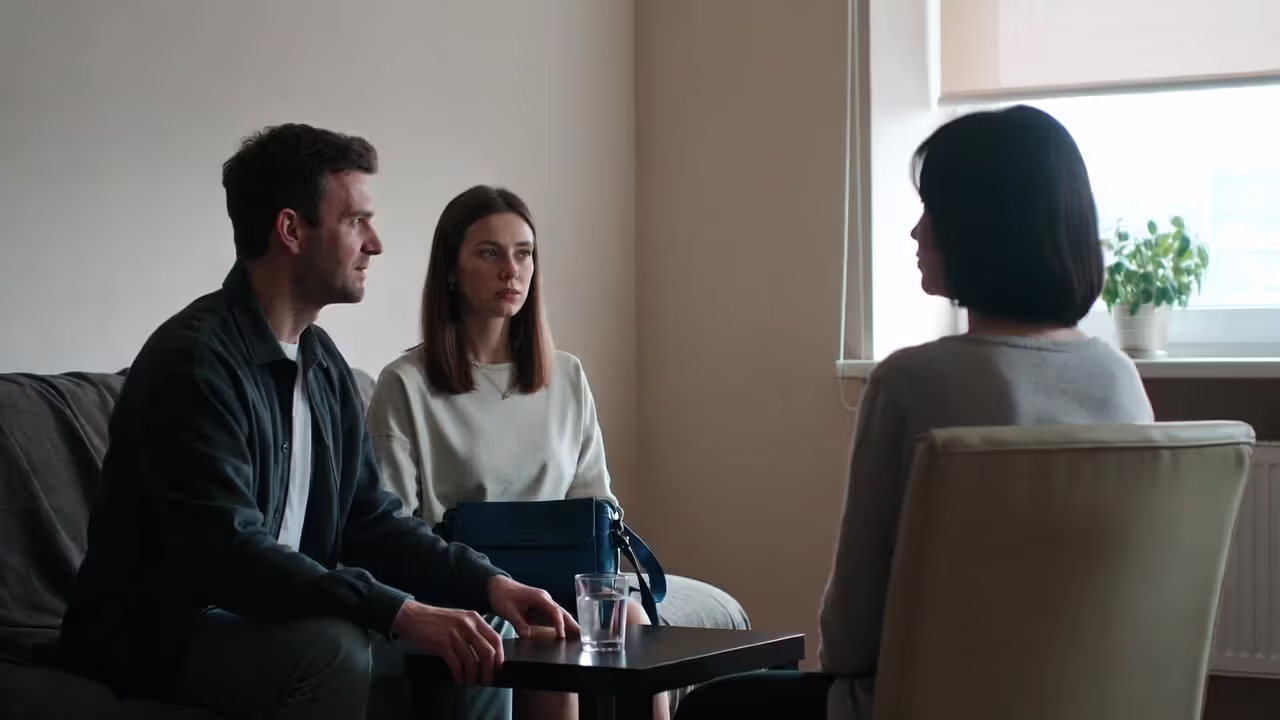 Couple talking with a therapist in a calm counseling office
